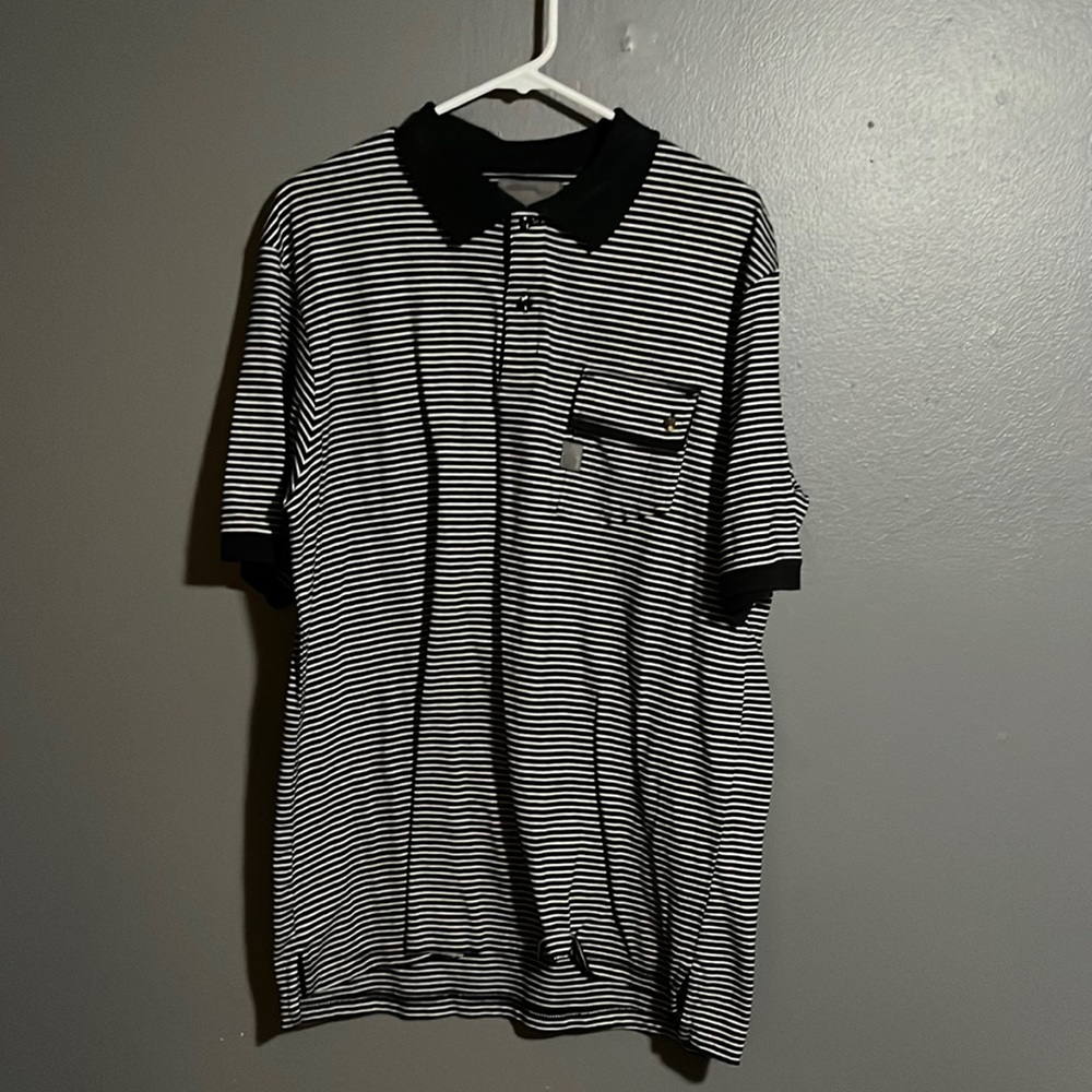 Navy blue and white Polo with pocket size XXL brand name is MCMXCIV